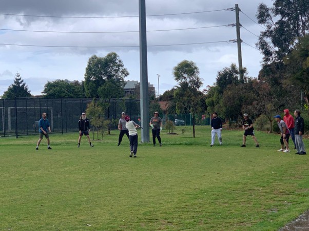 Quokkas in an arc taking catches off the bat prior to the match starting