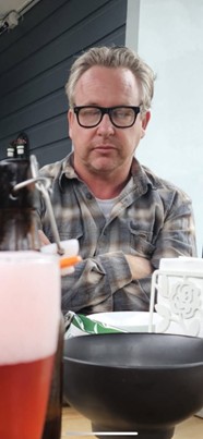 Fargo at his best having a micronap sitting up in front his beer at the batbar